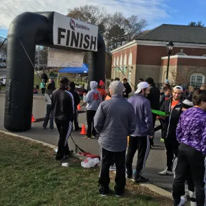 Runners gathering near the inflatable finish line arch