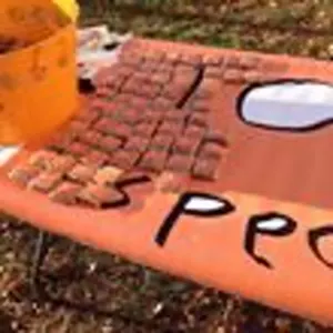 Close-up of individually wrapped treats laid out on the hand-painted orange banner