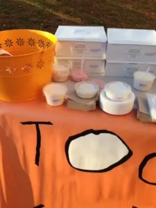 Cups and boxes of treats on the Today's Special table beside a flowered orange bowl